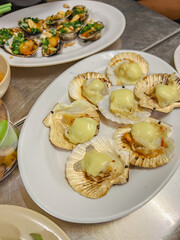 So diep nuong pho mai or chargrilled scallops with a cheese cube on top. A Vietnamese food. This seafood dish is highly popular in Vietnam. It can be both street food or high-end. The meat are juicy