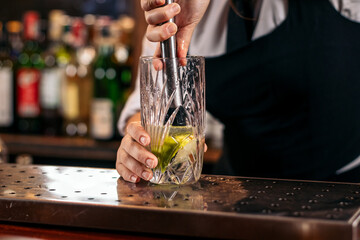 Bartender preparing a mojito in a cocktail bar