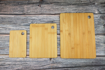 Wood cutting board for homemade bread cooking isolated on rusty background. Empty wooden tray at rusty