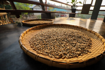 Raw coffee beans that farmers bring to enjoy the sunshine in the morning. before being roasted for...
