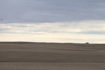 Fototapeta na wymiar Farmer feild with white sky and grey clouds, north photo