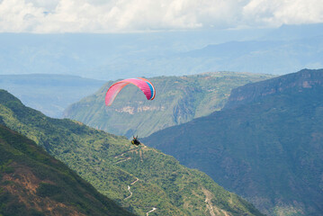 Paragliding in the Chicamocha Canyon area, Santander, Colombia. Paraglider flying enjoying the...