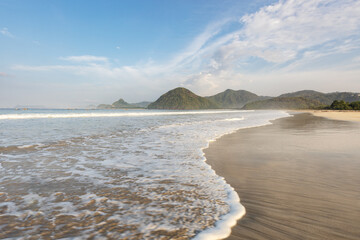Picturesque bay and breaking waves of Selong Belanak pure white sand beach on the tropical Lombok...