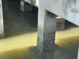 the bridge in the city of the most polluted towns, cement bridge pole near river.