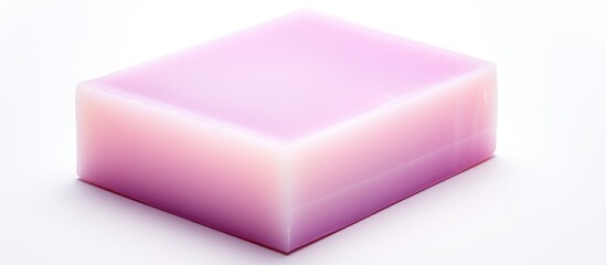 A vibrant purple soap cube sits on a clean white surface, beside a soft pink liquid