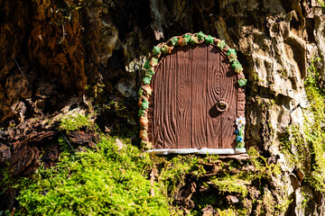 small door made of polymer clay on in nature like a fairy house close up