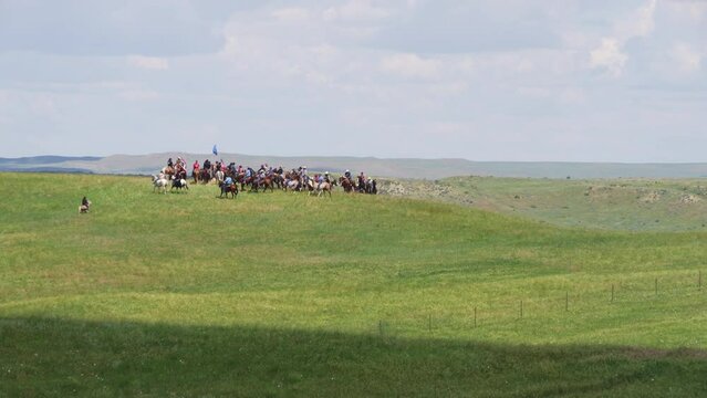 Re-enactors on horses circle on hill at Little Big Horn