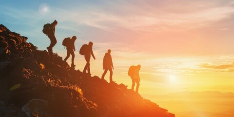 A group of people are hiking up a mountain, with the sun setting in the background. Scene is one of adventure and camaraderie, as the group works together to reach the summit - obrazy, fototapety, plakaty