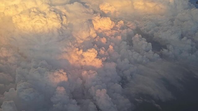 Airplane flight, flying above the sky clouds on sunset. View from the window of the plane in Vietnam dosmetic flight. 