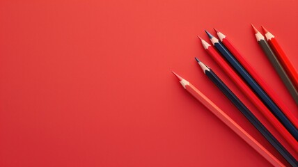 Group of sharp colored pencils is arranged diagonally on vibrant red background - Powered by Adobe