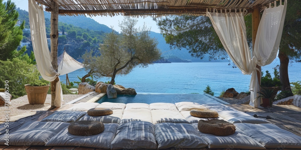 Poster a beach house with a pool and a view of the ocean. the pool is surrounded by white pillows and a can