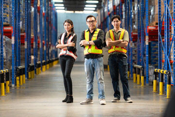 Portrait of group employees in the warehouse with arms crossed