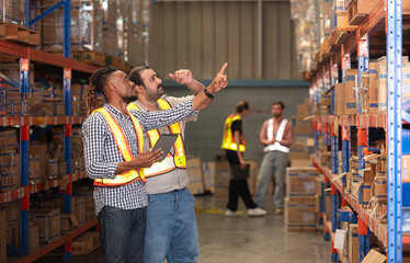 A group of warehouse employees, Inspecting products on warehouse shelves before they are sent to...