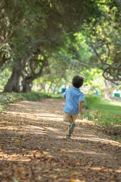 Child running free and happy in a park in Lima peru