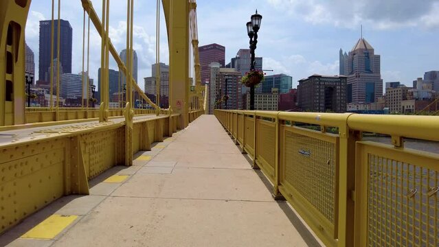 Walking over a bridge towards downtown Pittsburgh.
