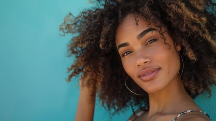 A woman with natural curls embracing her hair texture, promoting self-love. 