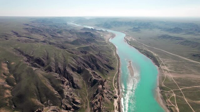 Drone shot of river Ili and spring steppe in Kazakhstan