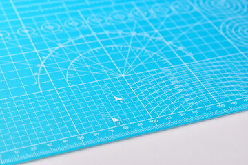 blue cutting mat board on white background with line and scale measure guide pattern for object art design, tool equipment of diy craft work