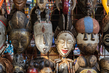 Coleção de máscaras africanas tradicionais em exposição. - obrazy, fototapety, plakaty