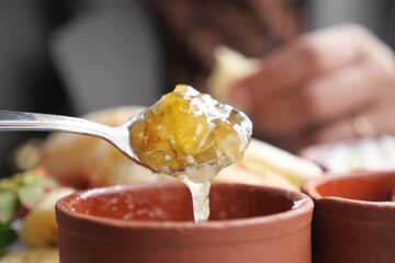 woman hand spoon picks fresh honey 