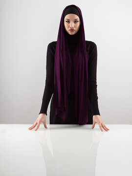 Muslim woman wearing modern stylish wear and hijab isolated on grey background. Diverse people model hijab fashion concept.