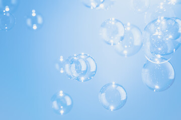 Beautiful Transparent Soap Bubbles Floating in The Air.  Celebration Festive Backdrop. Freshness Soap Suds Bubbles Water. Abstract Blue Textured Background.	