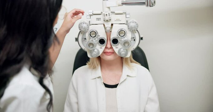 Ophthalmologist, woman and eye exam on phoropter for healthcare, wellness or consultation. Medical test, optometry and patient on machine for vision, eyesight or check on lens with doctor in clinic