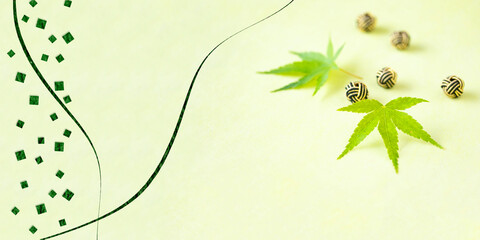 カエデの若葉と水引の切り絵風デザイン（黄緑の背景）