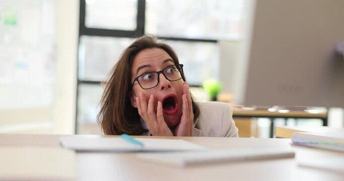 Manager woman peeking out of fear from behind desk in office