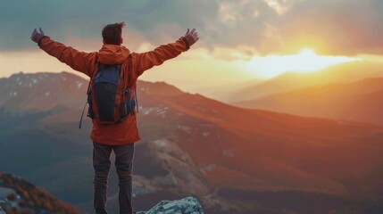A man standing on top of a mountain with his arms outstretched. Perfect for outdoor enthusiasts - obrazy, fototapety, plakaty