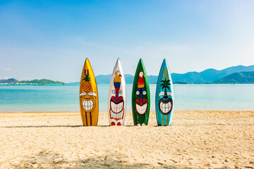 Surf board in the sand at the beach. Colorful surf board on the beach