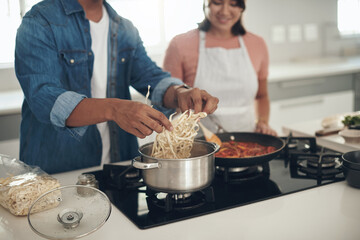 Pasta, cooking and couple in kitchen together with healthy food, relationship and bonding in home....