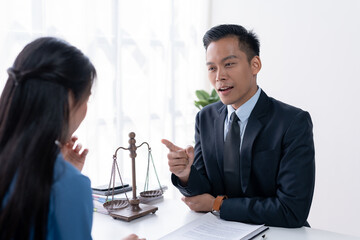 An engaged conversation between a lawyer and a client, with the lawyer pointing out important details.