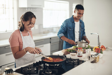 Helping, cooking and couple in kitchen together with healthy food, relationship and bonding in...