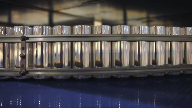 Conveyor line with the production of aluminum cans. Production of aluminum cans for drinks. Plant of high-tech equipment for the food industry.
