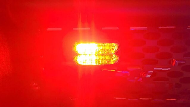 This is a short video of emergency lights, being activated, on an emergency first response vehicle. The lights have a strobe effect with red and blue colors.