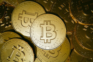 bitcoin, a heap of golden bitcoins with focus on one single bitcoin - 3D illustration