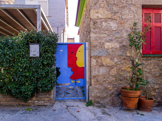 An unusual, colorful design house entrance with red, blue and yellow painted door. Travel to Athens, Greece. - 781087294