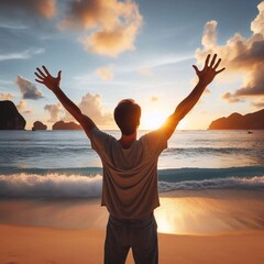 Happy man raising his hands up while enjoying the sunset on the beach