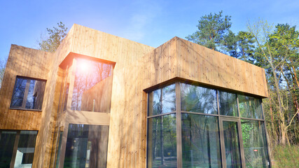 New single family house. Residential home with modern wooden facade. 