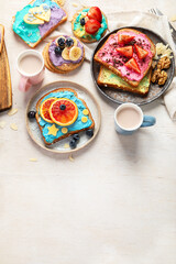 Sweet breakfast with cup of cocoa. Toast with cream cheese, banana, strawberries, blueberries