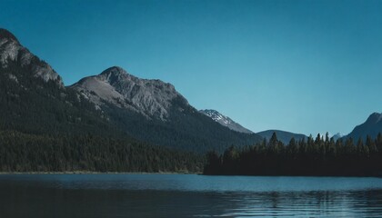 lake near mountain range under blue sky in alberta canada - Powered by Adobe