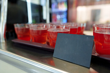 Colorful Array of Fruit Juice Cups on a Serving Cart in a Cafeteria