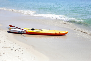 Yellow supboard on the beach