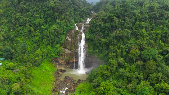 Waterfall in the rainforest. Tropical Aberdeen Falls in mountain jungle. Sri Lanka.