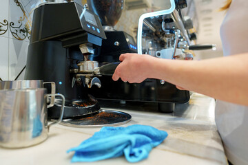 Barista Operating Espresso Machine at a Busy Coffee Shop During Morning Rush