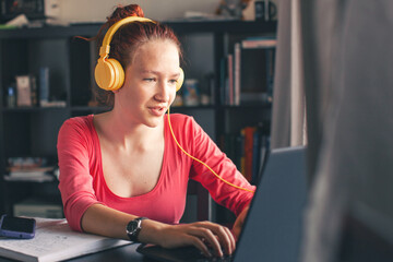 Millennial student sit at desk study on laptop