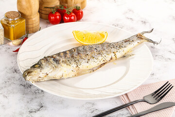 Grilled sea bass fish served lemon