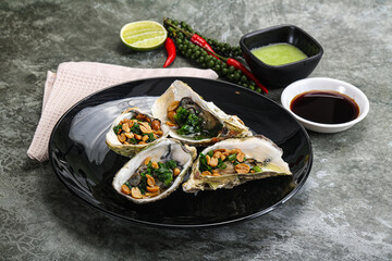 Open half oysters with green onion