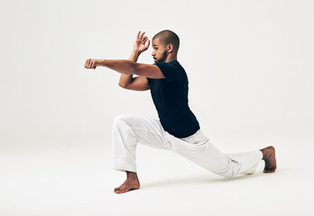 Man, studio and martial arts for attack position, action and karate exercise on white background....